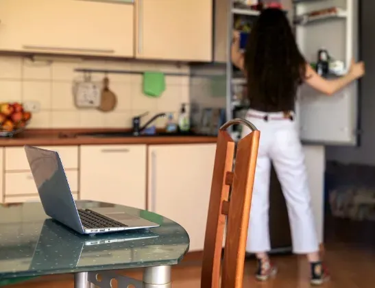 woman reaching for something in fridge background